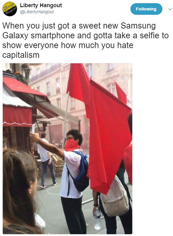 Social activist raging against capitalism by taking a pic about it on his Samsung Galaxy smartphone without realizing the irony.