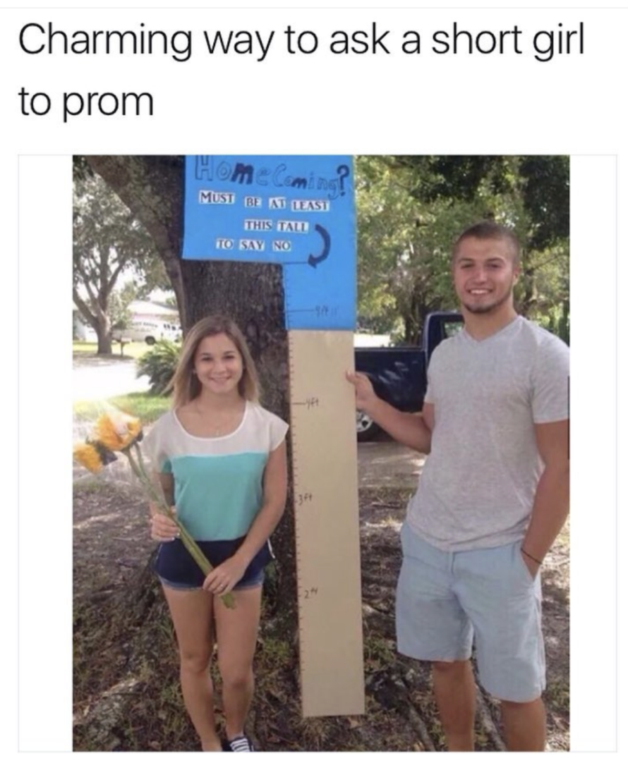 Man asking a short girl out to prom with a sign saying she has to be a certain height to say no, of which she is much shorter.