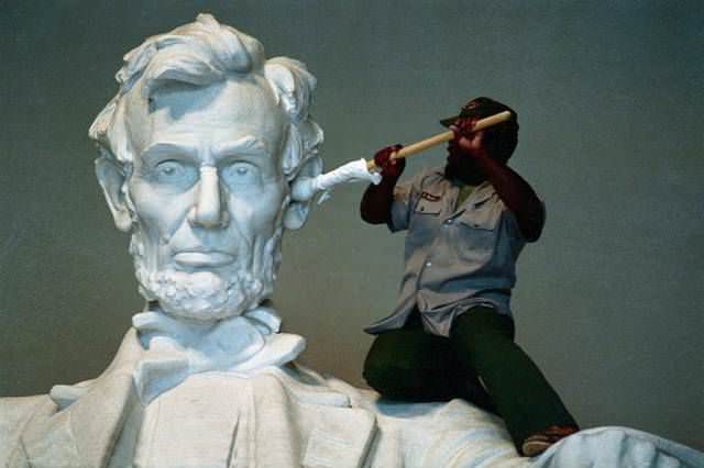 Worker cleaning Abraham's Lincoln ear with a giant q-tip