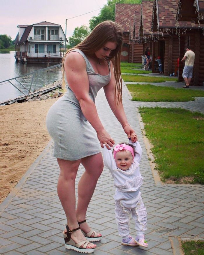 woman helping out her toddler learn to walk