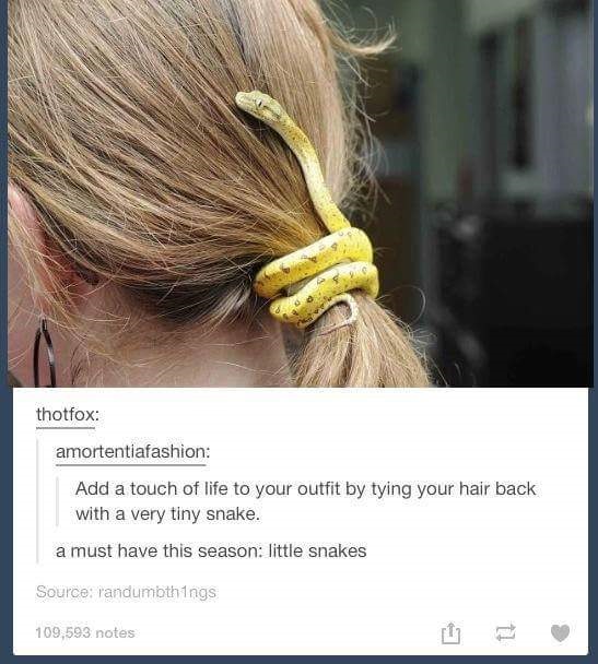 Woman wearing a snake in her hair to keep it bunched up.