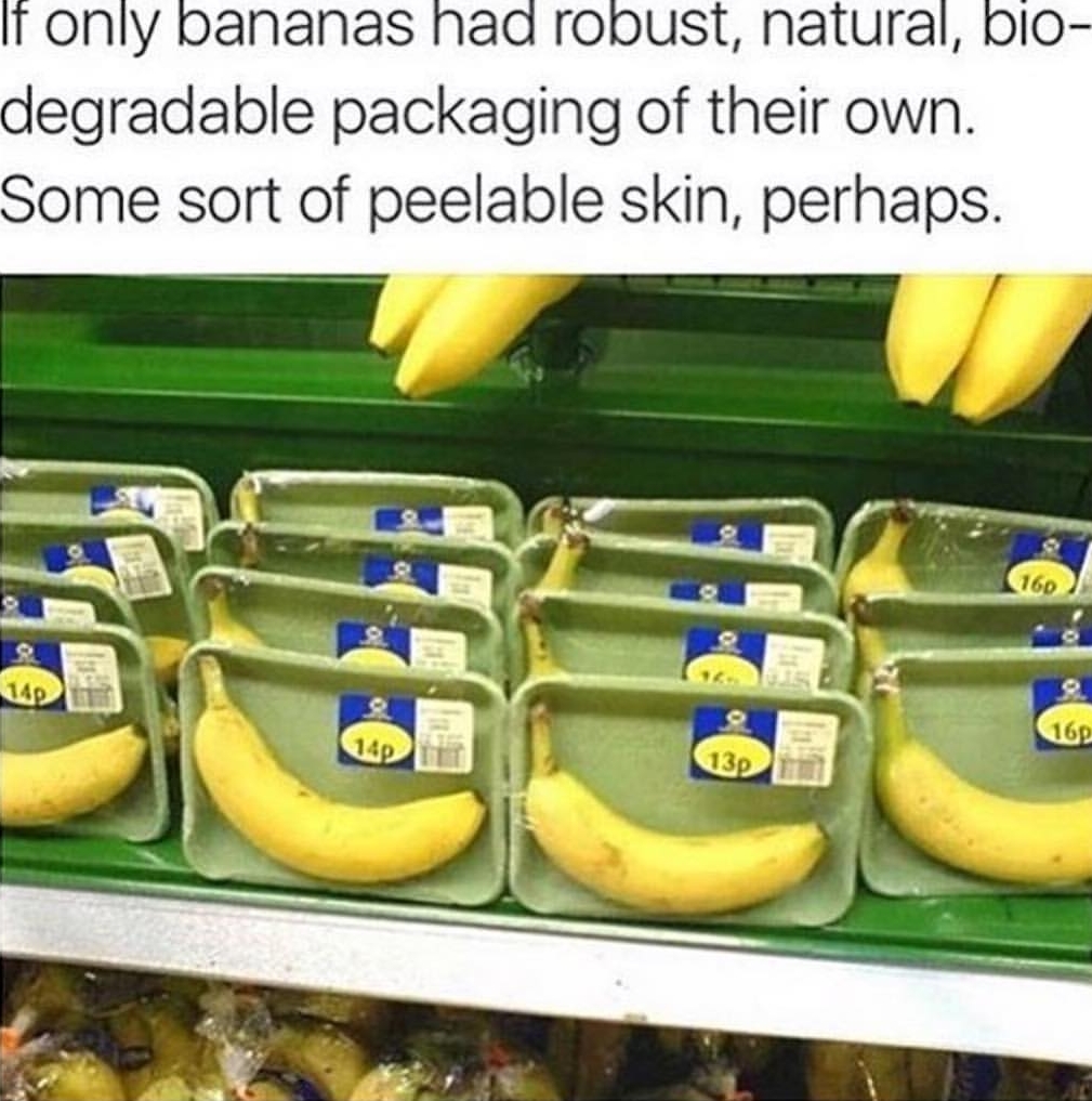 Shopping market in UK that is selling bananas wrapped on a tray.