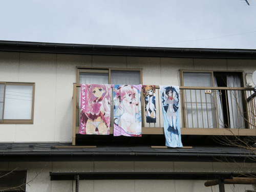 Laundry hung out to dry consisting of Anime towels and one is the obvious Waifu