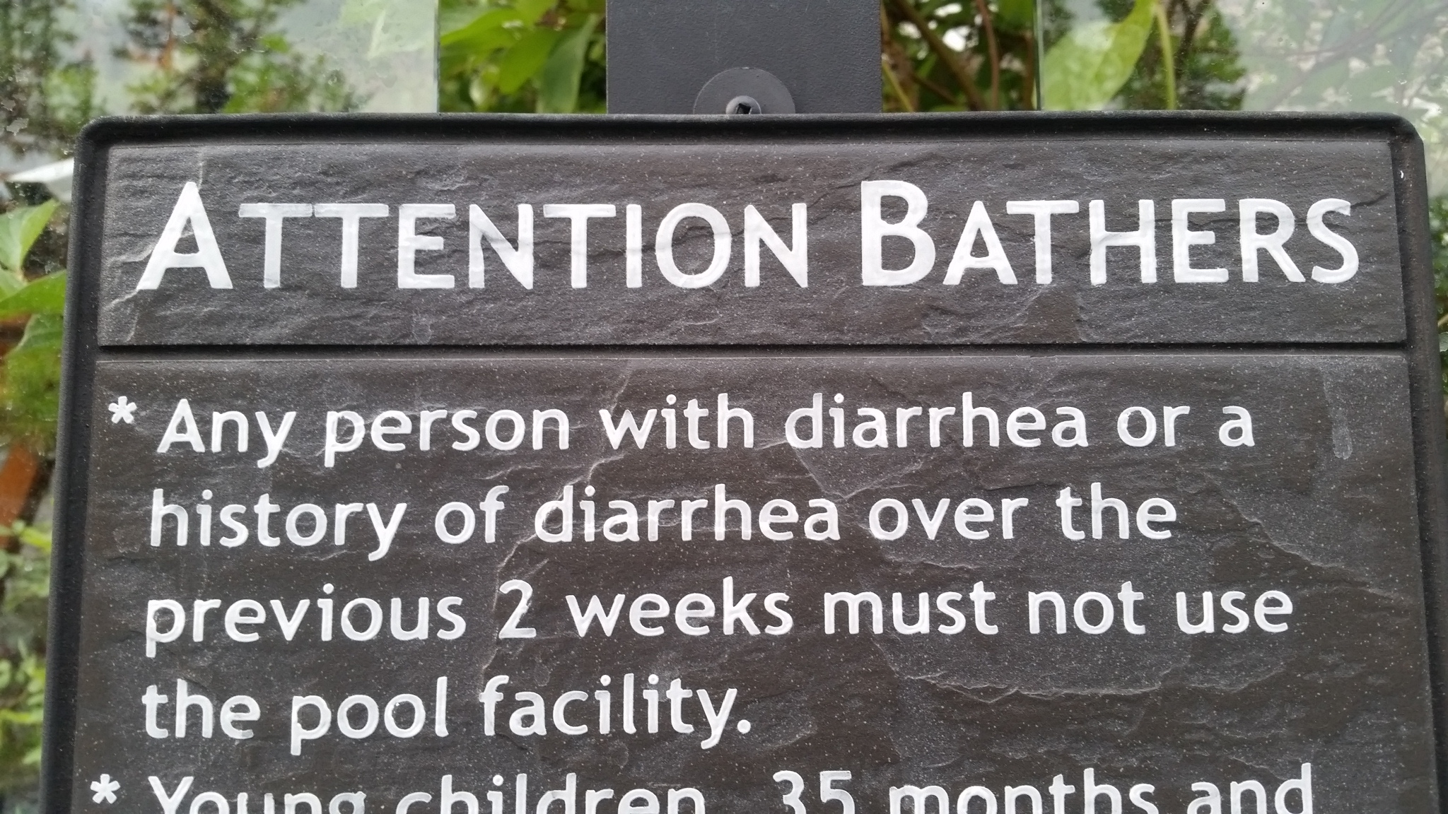 Funny picture of a strange sign warning bathers with diarrhea to stay out of the pool