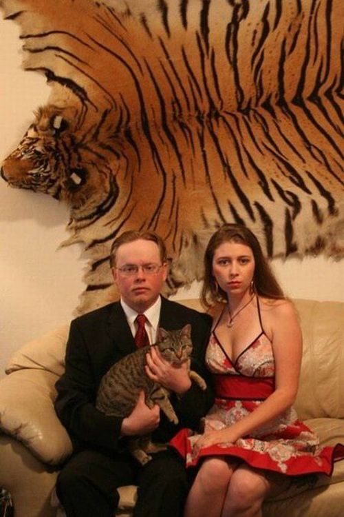 strange portrait of couple that has tiger fur on the wall behind them