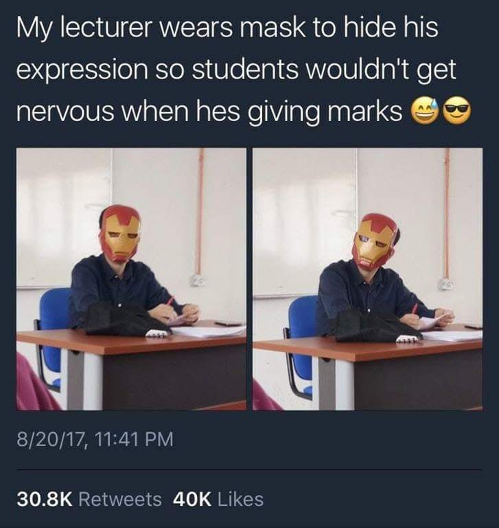 Funny tweet of teacher that wears Iron Man mas while grading papers so students can't read his facial expression while he is giving marks