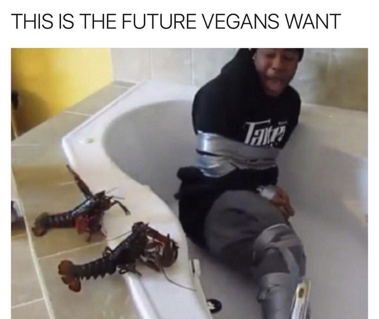 Man in a tub tied up with duct tape and threatened by lobsters, this is the future vegans want