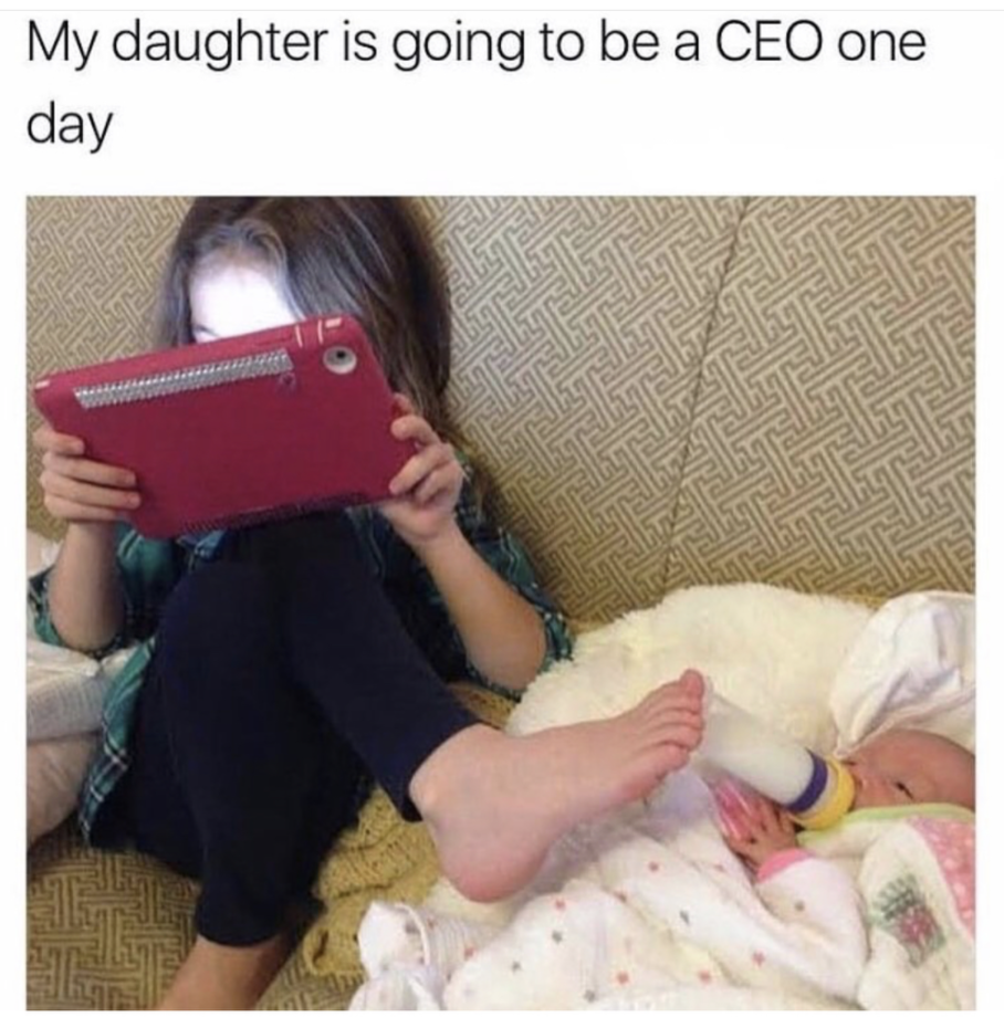Funny pic of daughter who is on the tablet and feeding little sister with holding the bottle with her feet. Mom thinks she will be CEO one day.