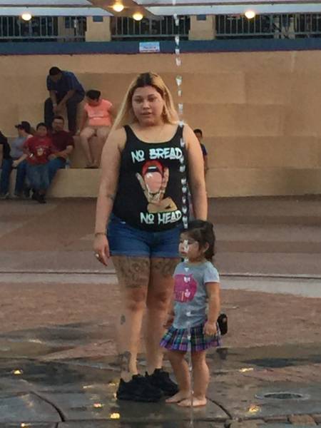 Girl with horrible message on her tank top shirt.