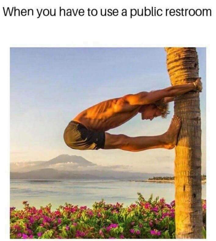 Man stretching on a palm tree on how it feels when you have to use a public restroom