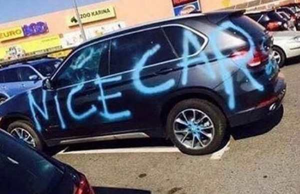 NICE CAR spray painted on someone's car