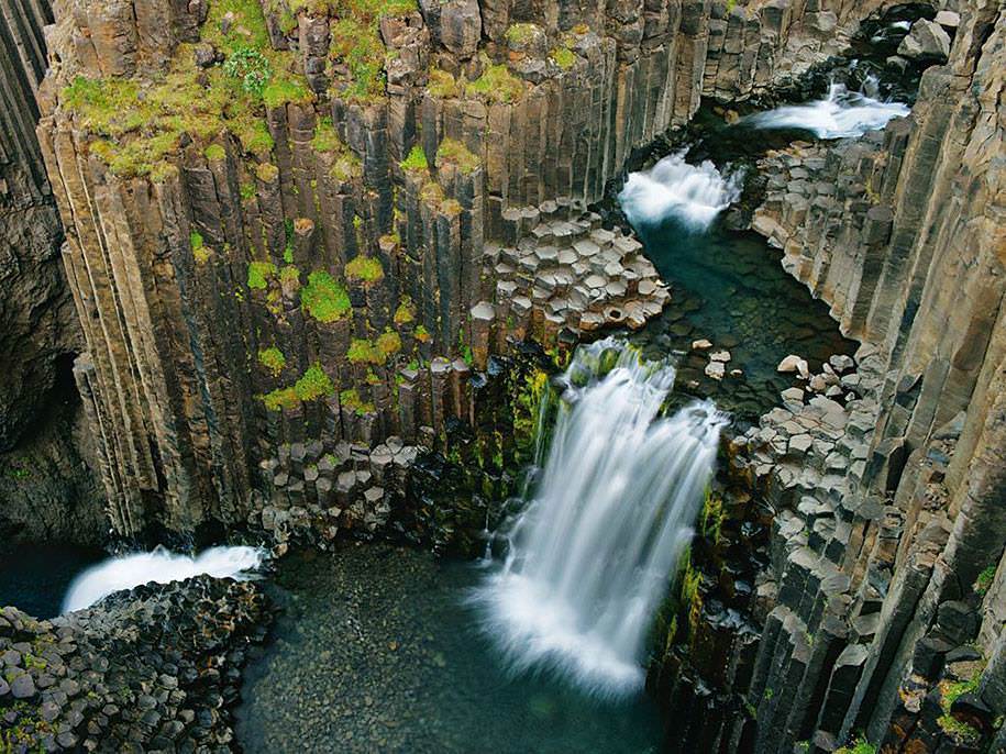 awesome picture of a water fall over hexagon rocks