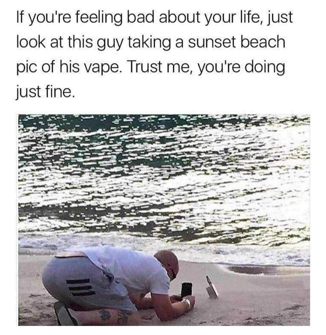 guy taking pic of vape on beach - If you're feeling bad about your life, just look at this guy taking a sunset beach pic of his vape. Trust me, you're doing just fine.