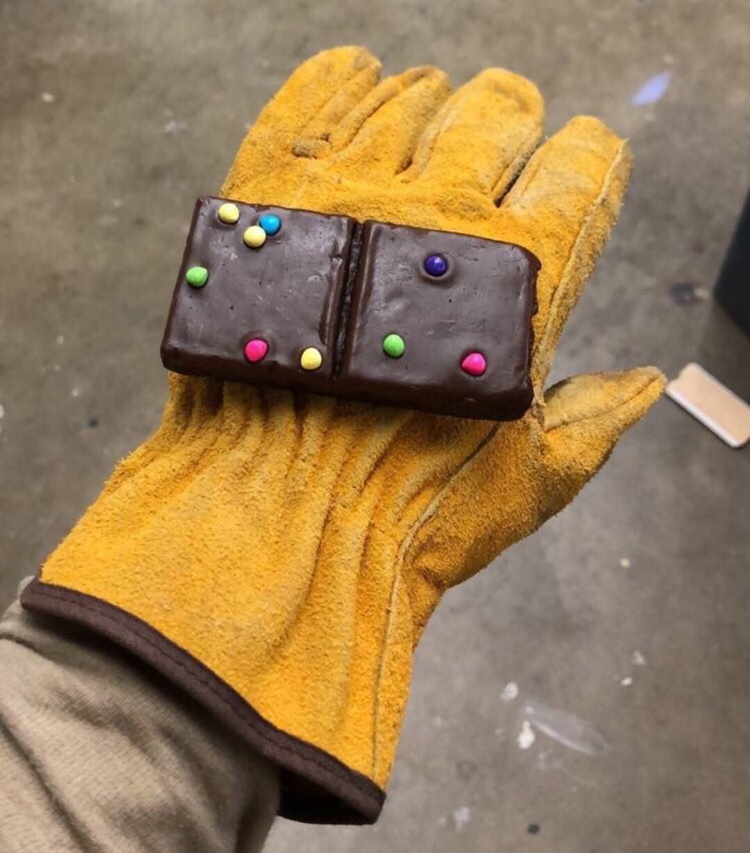 Infinity gauntlet made of a cosmic brownies on a yellow glove