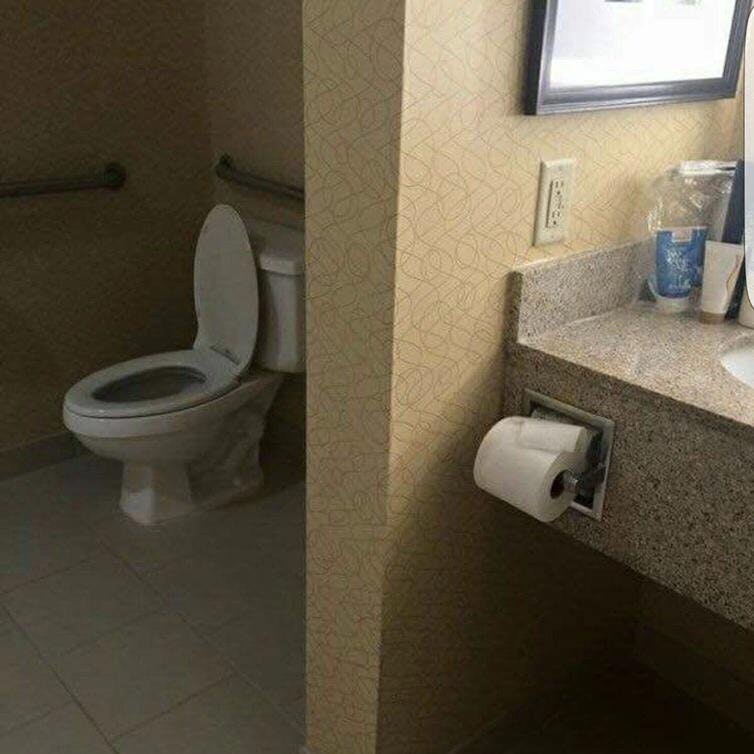 infuriating design of a bathroom where the toilet paper is far away from the porcelain throne, at least a stride and a half