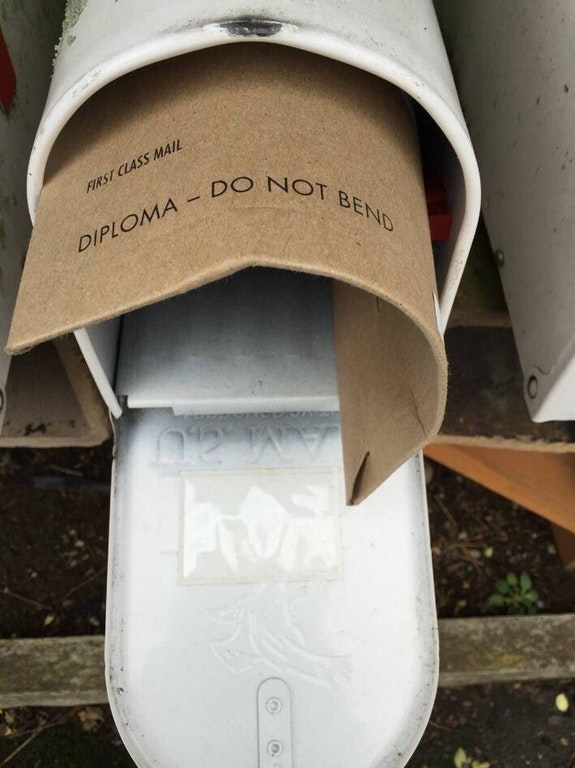 infuriating photograph of someone who got their diploma in the mailbox and it says DO NOT BEND and it is all bent