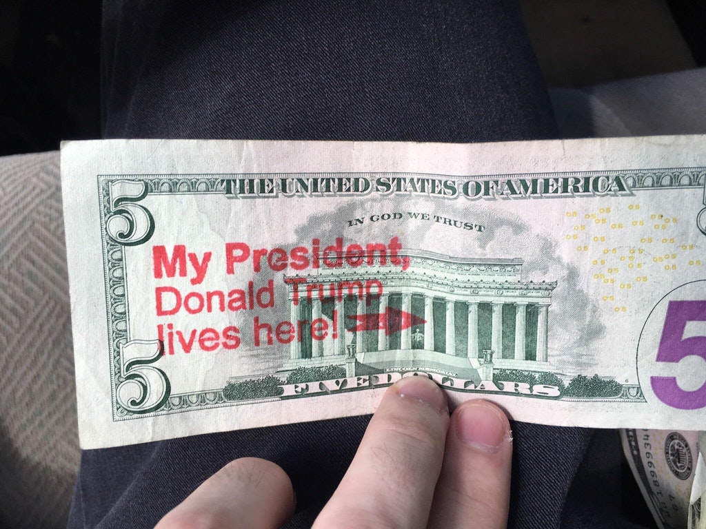 Stamp on a five dollar bill of My President Lives Here with arrow at the Lincoln memorial