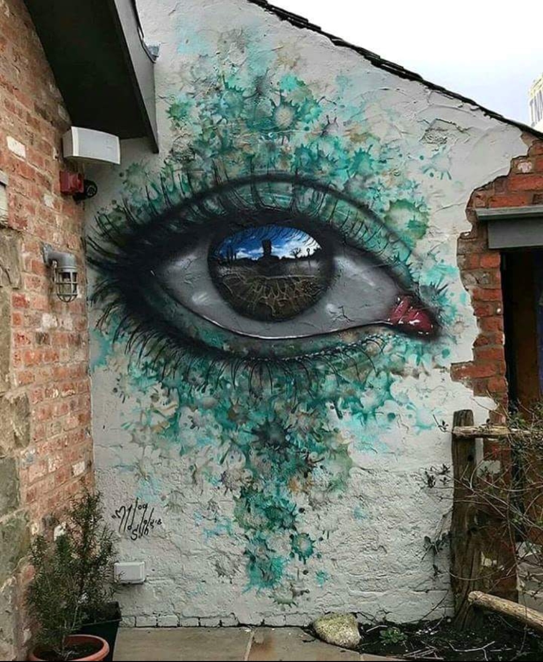 painting of eye on brick wall that looks amazingly detailed