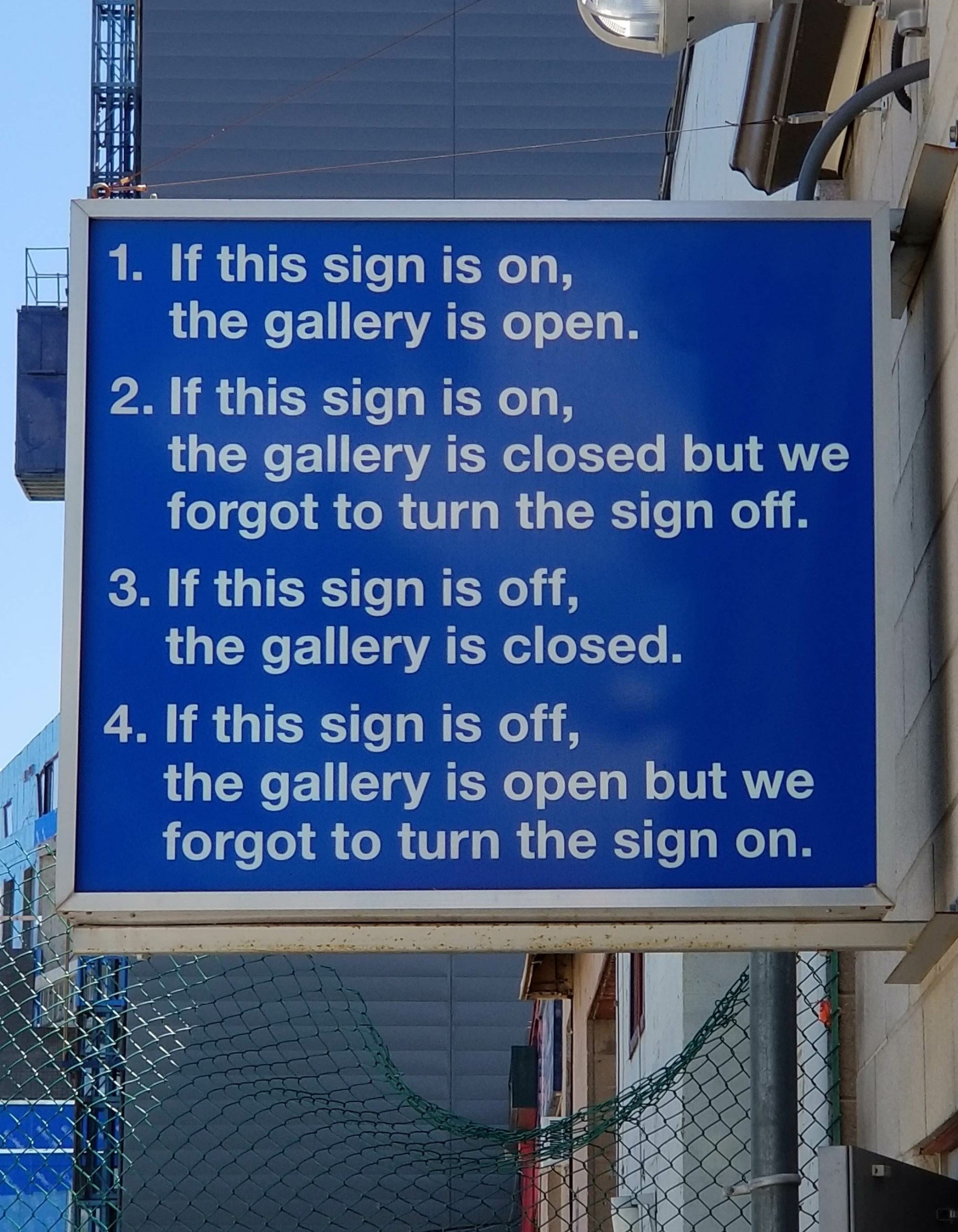 street sign - 1. If this sign is on, the gallery is open. 2. If this sign is on, the gallery is closed but we forgot to turn the sign off. 3. If this sign is off, the gallery is closed. 4. If this sign is off, the gallery is open but we forgot to turn the