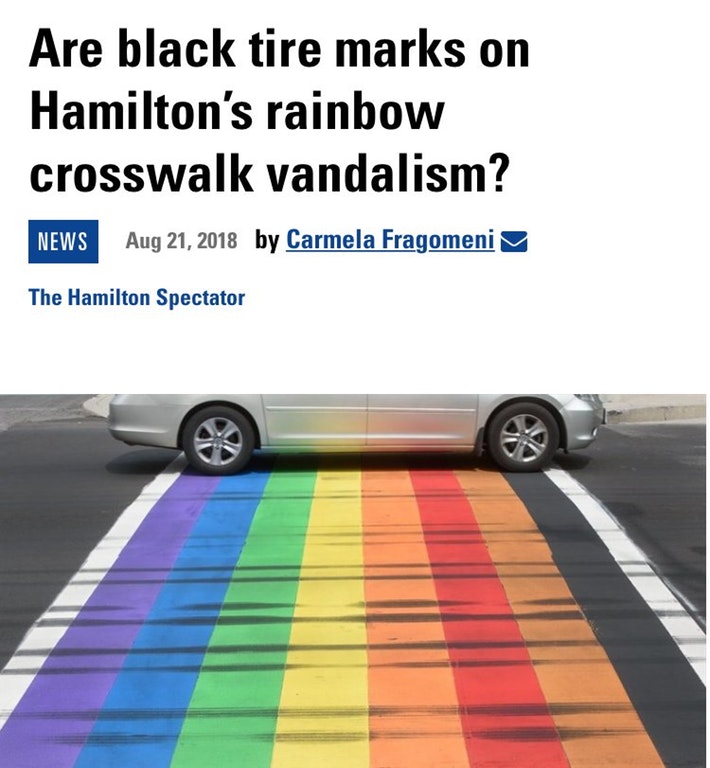Headline wondering if black tire marks across rainbow crosswalk is vandalism