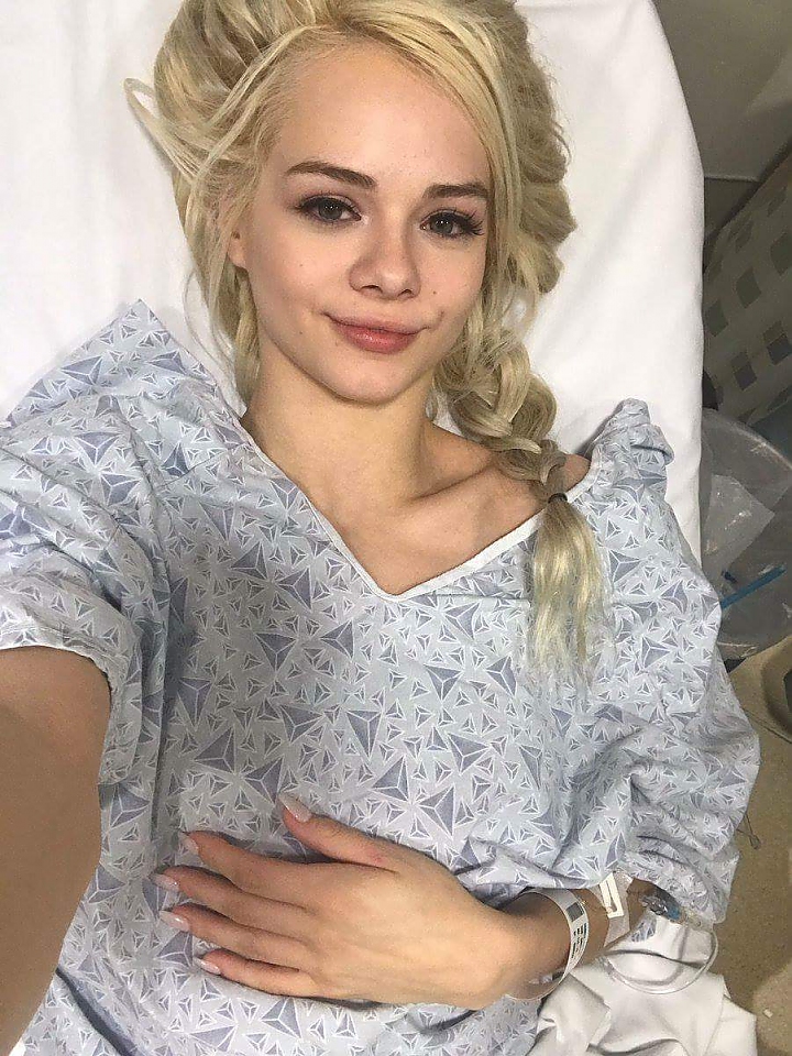 Elsa Jean taking a selfie in a hospital bed.