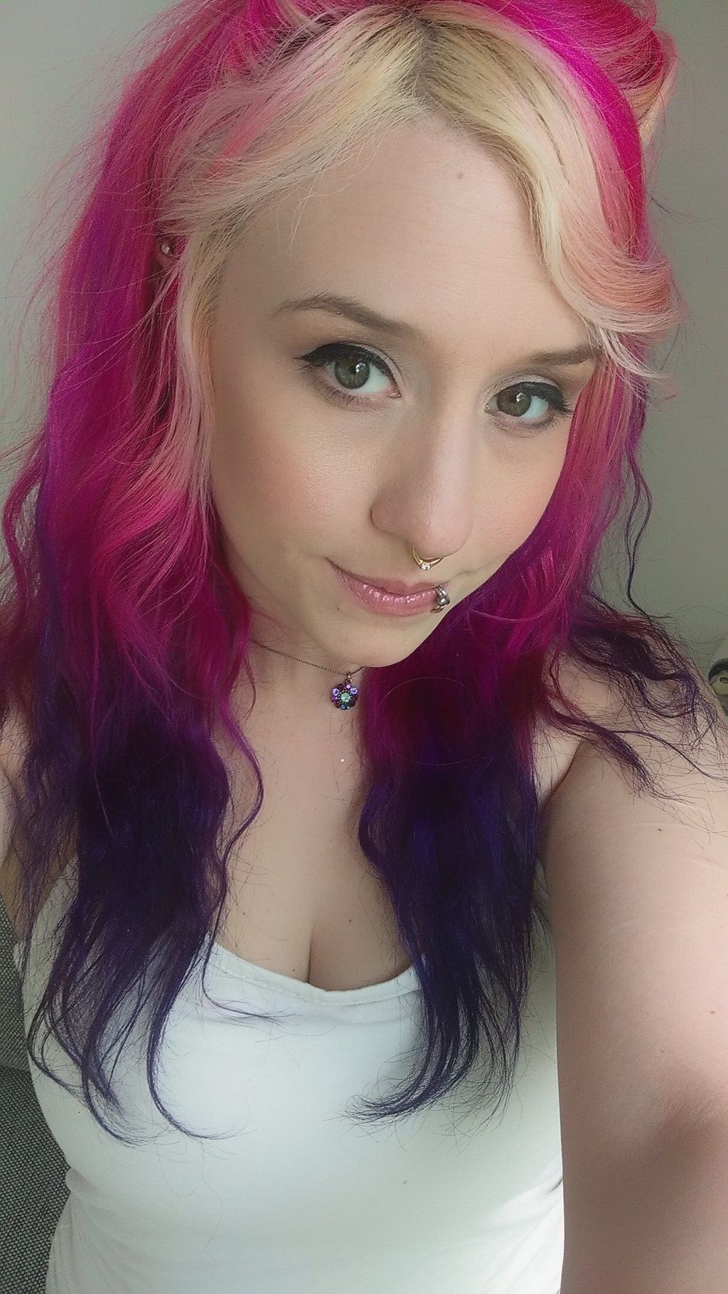 Proxy Paige with pink hair and a white shirt taking a selfie.