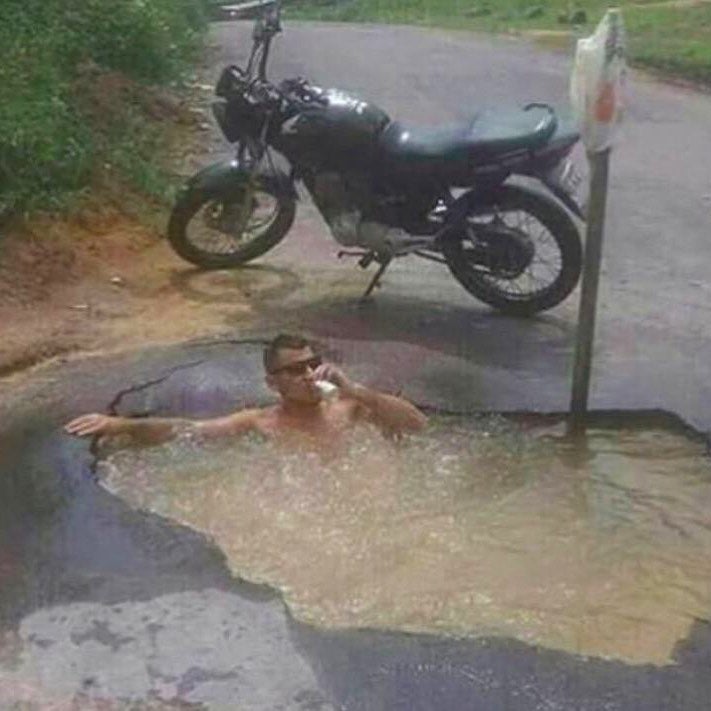 cursed_image of motorcycle pothole