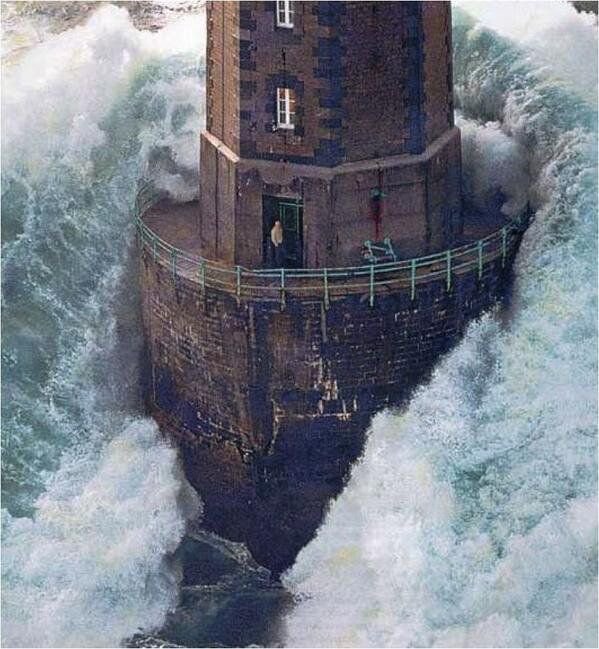 wave hitting lighthouse