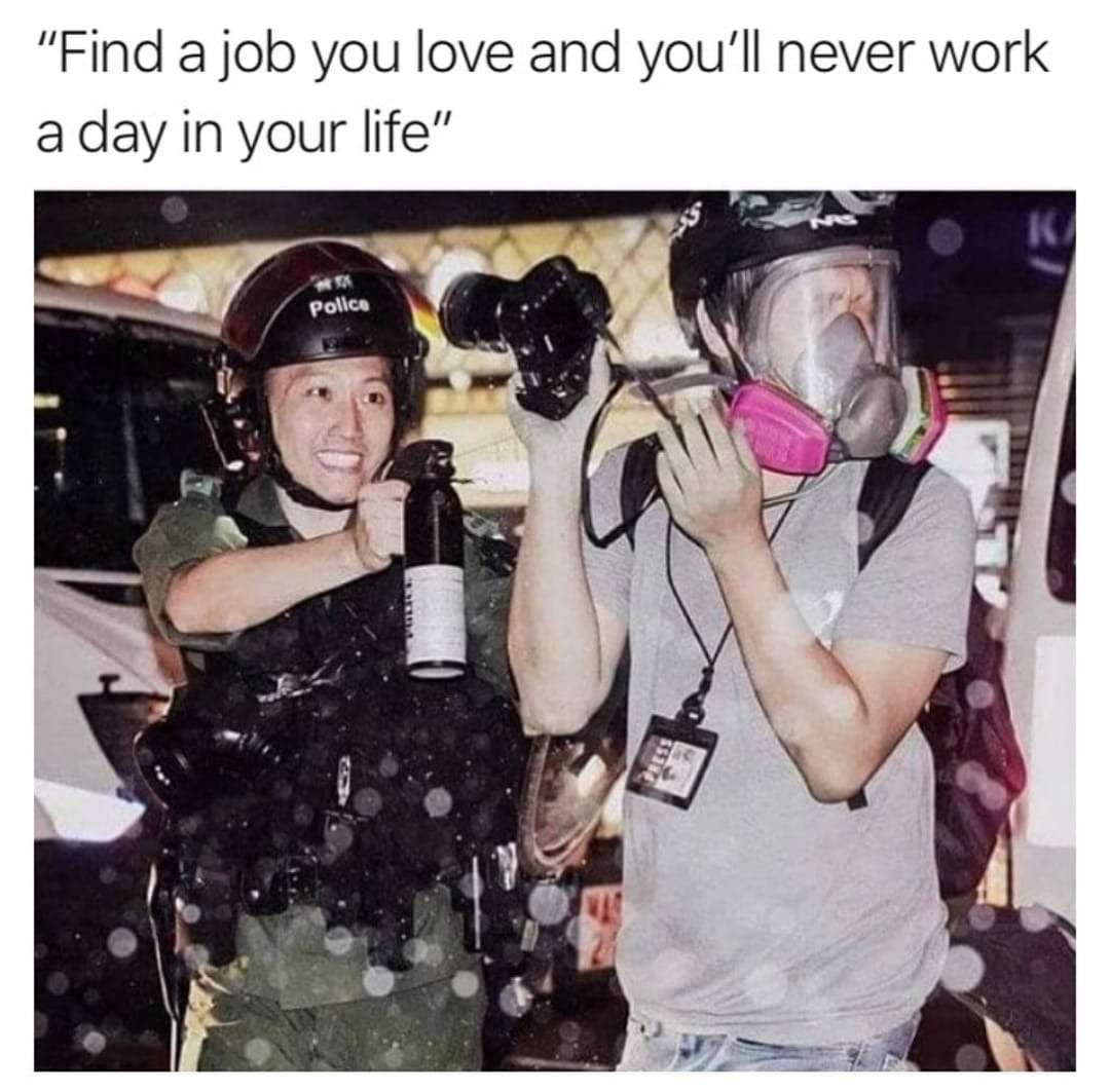 hong kong police smiling pepper spray - "Find a job you love and you'll never work a day in your life" Police
