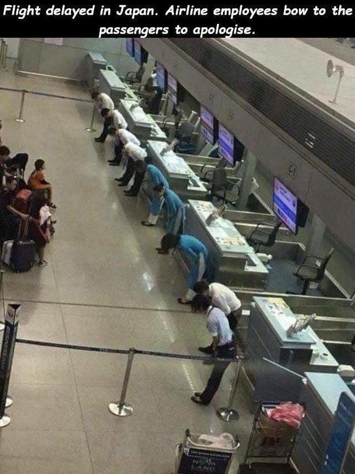 Flight delayed in Japan. Airline employees bow to the passengers to apologise.