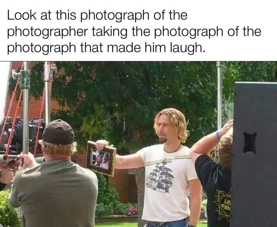 look at this photograph of a man holding a photograph - Look at this photograph of the photographer taking the photograph of the photograph that made him laugh. Le Silk