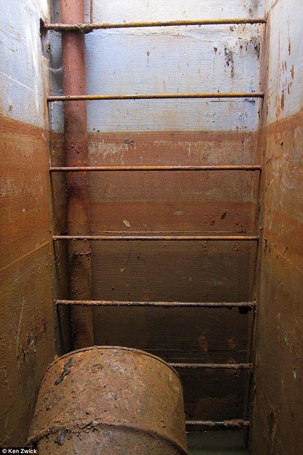 This ladder led down to the bunker, which was filled with water. There were boxes floating, filled with supplies.