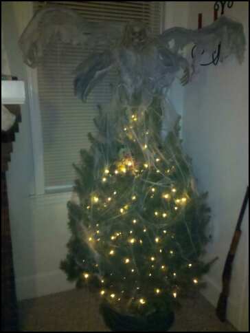 Scary angel on top and covered in spider webs... Merry Christmas Doodz!