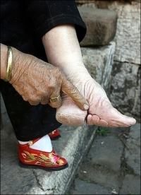 At 3yrs in the 10th century in china their feet were broken and bent under the sole of the foot.