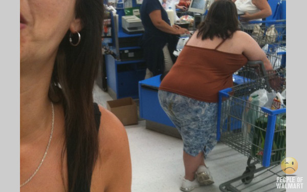 No, the brown in the crack of her ass is not part of the pants pattern. And the woman in the forefront must've been first to notice.