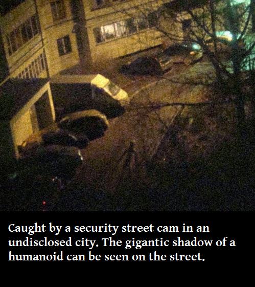 stickman sighting - Caught by a security street cam in an undisclosed city. The gigantic shadow of a humanoid can be seen on the street.