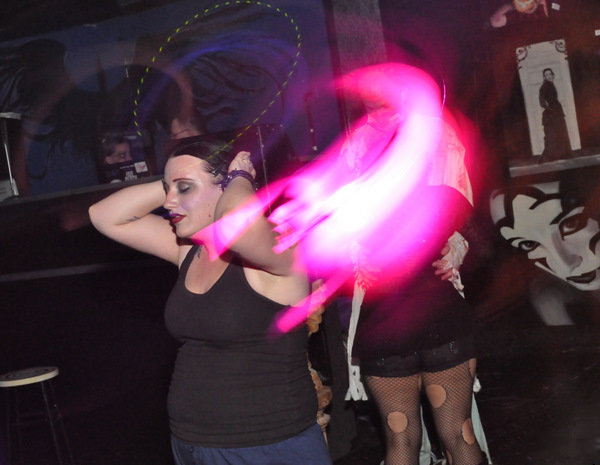 Taken on another regular night at a girl's regular club. Not only does the image suggest something other than her friends were dancing with her, but she claims the pink wisp shows the profile of a face as well.