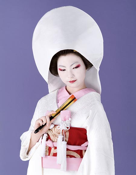 Japanese brides are known to wear head-to-toe white only in cases of traditional Shinto ceremonies. The silk hood, or wataboshi, is to symbolize patience.