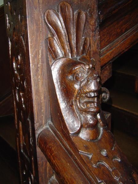 A banister carving on the stairway of Charlton House in Kent. Faces start out normal at the base of the stairs but become more warped as you ascend. Supposedly this house once belonged to a Satanist.