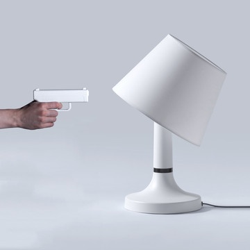 Gun remote "shoots"  your light off and causes shade to tilt back when you do. Cuz the Clapper isn't convenient enough.