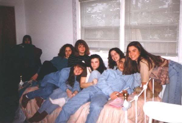 This photo was taken in 1994 during a sweet 16 party. Nobody has any clue who the shrouded girl in the corner is.