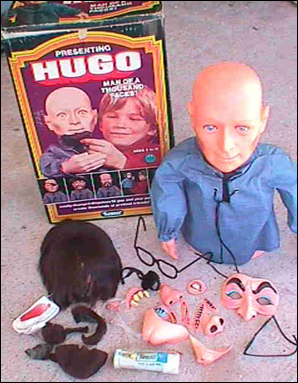 A hairless, vacant expression, a trunk full of disguises, a bolo tie--without question, Hugo is a man of a thousand serial murders.  This doll is like a Ted Bundy Potato Head. The face on the box has the ghoulish stare of a guy that literally can't wait to stab you to death and drag your body down to his basement. He's even wearing disposable clothing, presumably to be wrapped around severed limbs to keep them from bleeding all over the interior of the station wagon of a thousand screams.  But on top of all that... why the fuck does he need those creepy little atrophied arms? They serve no purpose! They intentionally went out of their way in the manufacturing process to make him just a little more terrifying.