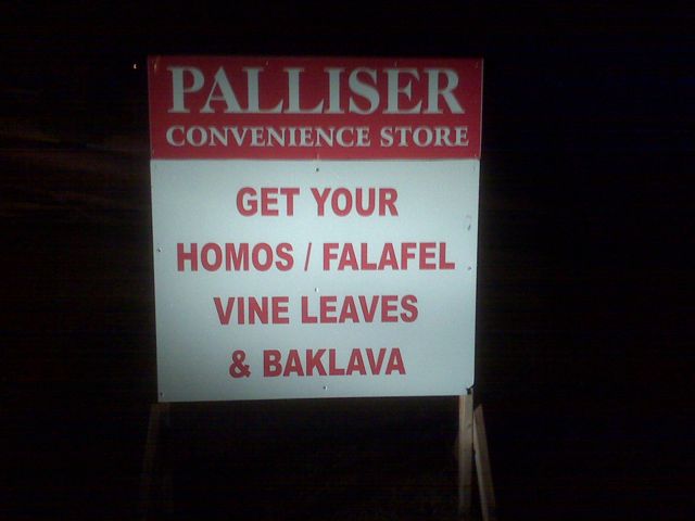 A Sign located in front of "Palliser Convenience Store" promoting their homo products.