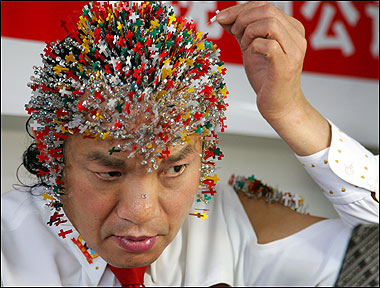 The most needles on the head is 2,009 and was achieved by Wei Shengchu China