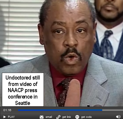 Undoctored screen capture from an AP news video of the June 15th NAACP press conference in Seattle, to protest the punching of a black woman by a white cop.

The man in the picture is James Bible, head of the Seattle NAACP. And the...uh...thing that hes about to blow into...I hope to god its a microphone. 
