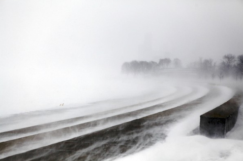 The Chicago lakefront is lost in blowing snow on the second day of the storm.