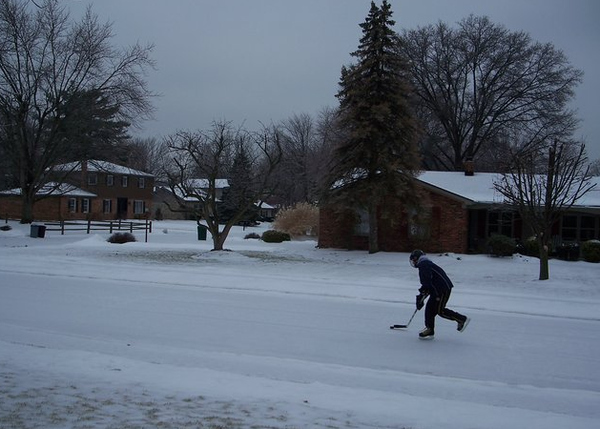 A kid playing ice hockey on Grand Avenue in Castleton, Indiana