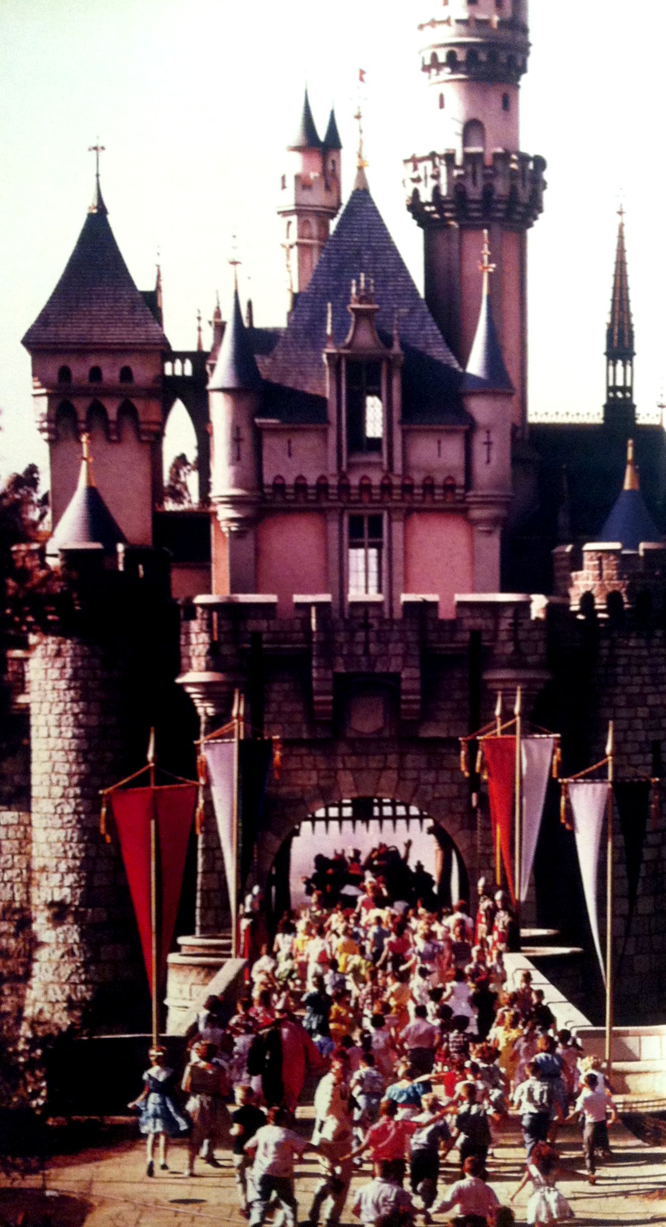Crowds rush through the castle on Disneyland's opening day in 1955.