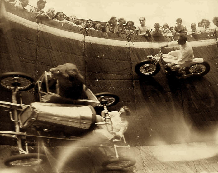 A lion rides in the sidecar during a performance of The Wall of Death carnival attraction at Revere Beach, Massachusetts in 1929.