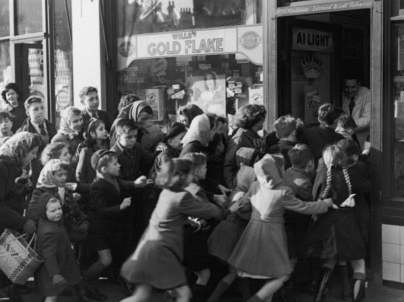 Children rush into a candy store following the end of "sweets rationing" in 1953.
